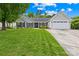 Charming single-story home featuring a well-maintained lawn, gray siding, black shutters, and an attached two-car garage at 4313 Wynborough Ln, Charlotte, NC 28269