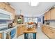 Bright eat-in kitchen with wooden island, light wood cabinets and tiled flooring at 4313 Wynborough Ln, Charlotte, NC 28269