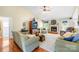 Open-concept living room with hardwood floors, vaulted ceilings, brick fireplace, and comfortable seating at 4313 Wynborough Ln, Charlotte, NC 28269