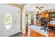 Inviting home office with hardwood floors, a large wooden desk, custom built-ins, and lots of natural light at 4313 Wynborough Ln, Charlotte, NC 28269
