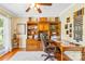 Spacious home office with custom wooden built-ins, hardwood floors, and a comfortable leather chair at 4313 Wynborough Ln, Charlotte, NC 28269