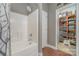 Bathroom featuring a white tub, a shower head, a white tile surround, and a view into a walk-in closet at 460 Clouds Way, Rock Hill, SC 29732