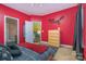 A bright bedroom with red walls, plush carpeting, and access to an ensuite bathroom and walk-in closet at 460 Clouds Way, Rock Hill, SC 29732