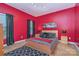 Bedroom featuring red walls, a queen bed, two side tables, black and white patterned bedding, and decorative carpet at 460 Clouds Way, Rock Hill, SC 29732