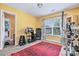 Bright exercise room with carpet, red rug, yellow walls, and large window at 460 Clouds Way, Rock Hill, SC 29732