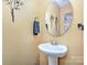 Powder room with pedestal sink, oval mirror, and neutral colored walls at 460 Clouds Way, Rock Hill, SC 29732