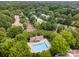 Aerial view of a community featuring a pool, surrounded by lush trees at 4703 David Cox Rd, Charlotte, NC 28269
