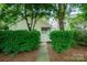 Private backyard featuring lush greenery and a gate, perfect for outdoor enjoyment at 4703 David Cox Rd, Charlotte, NC 28269