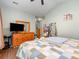 Bright bedroom featuring wood floors, dresser, mirror, and comfortable blue patterned bedspread at 4703 David Cox Rd, Charlotte, NC 28269