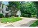 A beautiful home with manicured lawn and garden space showcasing the long driveway at 4703 David Cox Rd, Charlotte, NC 28269