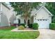 Charming home featuring a well-manicured lawn and a tree-lined yard with a one-car garage at 4703 David Cox Rd, Charlotte, NC 28269