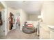 Hallway with neutral walls, closet, and sitting area with a beanbag chair and view into a bedroom at 4703 David Cox Rd, Charlotte, NC 28269
