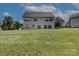 Backyard view of two-story home featuring an expansive lawn at 4966 Riverview Dr, Harrisburg, NC 28075