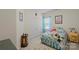 Inviting bedroom with neutral walls, closet, and bed with floral bedding at 4966 Riverview Dr, Harrisburg, NC 28075