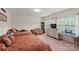 Spacious bedroom with two beds, a sitting area, and lots of natural light at 4966 Riverview Dr, Harrisburg, NC 28075