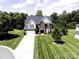 Traditional two-story home with brick and siding, featuring a manicured lawn and attached garage at 4966 Riverview Dr, Harrisburg, NC 28075