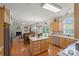 Spacious open kitchen with wood floors, stainless appliances, and breakfast island at 4966 Riverview Dr, Harrisburg, NC 28075