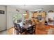 Eat-in kitchen features hardwood floors, natural wood cabinets, and stainless appliances at 4966 Riverview Dr, Harrisburg, NC 28075
