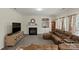 Comfortable living room with a fireplace, built-in shelving, and a plush leather sectional at 4966 Riverview Dr, Harrisburg, NC 28075