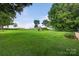 Spacious backyard offering a play set and a large grassy area perfect for outdoor activities and recreation at 5445 Creekwood Dr, Salisbury, NC 28147