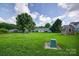 Spacious backyard with a playset, shed, and ample green space, perfect for outdoor activities and recreation at 5445 Creekwood Dr, Salisbury, NC 28147