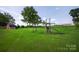 Expansive backyard featuring a wooden swing set and a storage shed on a lush green lawn at 5445 Creekwood Dr, Salisbury, NC 28147