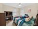 Neutral bedroom with a ceiling fan, bed, and a window overlooking the outdoor landscape at 5445 Creekwood Dr, Salisbury, NC 28147