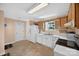 Bright kitchen featuring white appliances, wood cabinets, and a view from the window at 5445 Creekwood Dr, Salisbury, NC 28147