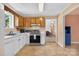 Kitchen featuring neutral walls, wood cabinets, and stainless steel appliances and view of the living room at 5445 Creekwood Dr, Salisbury, NC 28147