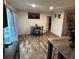 Cozy dining area with a modern table and chairs near a bright window and kitchen at 5707 S Rocky River Rd, Monroe, NC 28112
