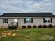 Charming single-story home with gray siding, black shutters, and well-maintained landscaping at 5707 S Rocky River Rd, Monroe, NC 28112