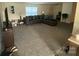 Bright living room with plush seating, carpet, and large windows at 5707 S Rocky River Rd, Monroe, NC 28112