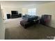 Spacious living room with neutral color palette, fireplace, and large windows at 5707 S Rocky River Rd, Monroe, NC 28112