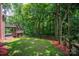 Multi-level deck overlooking a green lawn with fence and wooded area in the background at 6016 Graburns Ford Dr, Charlotte, NC 28269