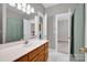 Bathroom with a white vanity, tile flooring, and open access to the laundry room at 6016 Graburns Ford Dr, Charlotte, NC 28269