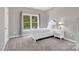 Bright bedroom with carpeted floor and a window letting in the natural light at 6016 Graburns Ford Dr, Charlotte, NC 28269