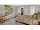 The bedroom with natural light from a large window, rocking chair, walk-in closet, and ensuite bathroom at 6016 Graburns Ford Dr, Charlotte, NC 28269