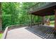 Large wooden deck with stairs on the back of the house overlooking the wooded backyard at 6016 Graburns Ford Dr, Charlotte, NC 28269