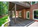 Large wooden deck on the back of a brick house with a door to the house and stairs to the yard at 6016 Graburns Ford Dr, Charlotte, NC 28269