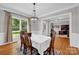 Dining room with hardwood floors, view to the front yard, and an office at 6016 Graburns Ford Dr, Charlotte, NC 28269