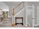 Bright foyer with staircase featuring wood and white trim at 6016 Graburns Ford Dr, Charlotte, NC 28269