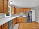Bright kitchen features wooden cabinets, white countertops, stainless steel appliances, and hardwood flooring at 6016 Graburns Ford Dr, Charlotte, NC 28269
