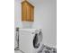 Convenient laundry room features a washer and dryer with overhead storage at 6016 Graburns Ford Dr, Charlotte, NC 28269