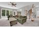 Inviting living room features comfortable seating, carpeted floors, and large windows with natural light at 6016 Graburns Ford Dr, Charlotte, NC 28269