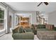 Cozy living room offers comfortable seating and leads to the staircase and bright kitchen area at 6016 Graburns Ford Dr, Charlotte, NC 28269