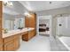 Main bathroom features double sinks, soaking tub, and frameless glass shower at 6016 Graburns Ford Dr, Charlotte, NC 28269
