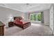 Spacious main bedroom features a tray ceiling, neutral paint, and windows offering ample natural light at 6016 Graburns Ford Dr, Charlotte, NC 28269
