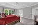 Bright main bedroom boasts a tray ceiling, neutral paint, and adjoining bathroom access at 6016 Graburns Ford Dr, Charlotte, NC 28269
