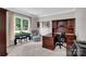 Comfortable carpeted office with large window, dark wood desk, and office furnishings at 6016 Graburns Ford Dr, Charlotte, NC 28269