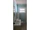 Small bathroom with a white sink, white toilet, and a window at 608 Sharon Dr, Statesville, NC 28625
